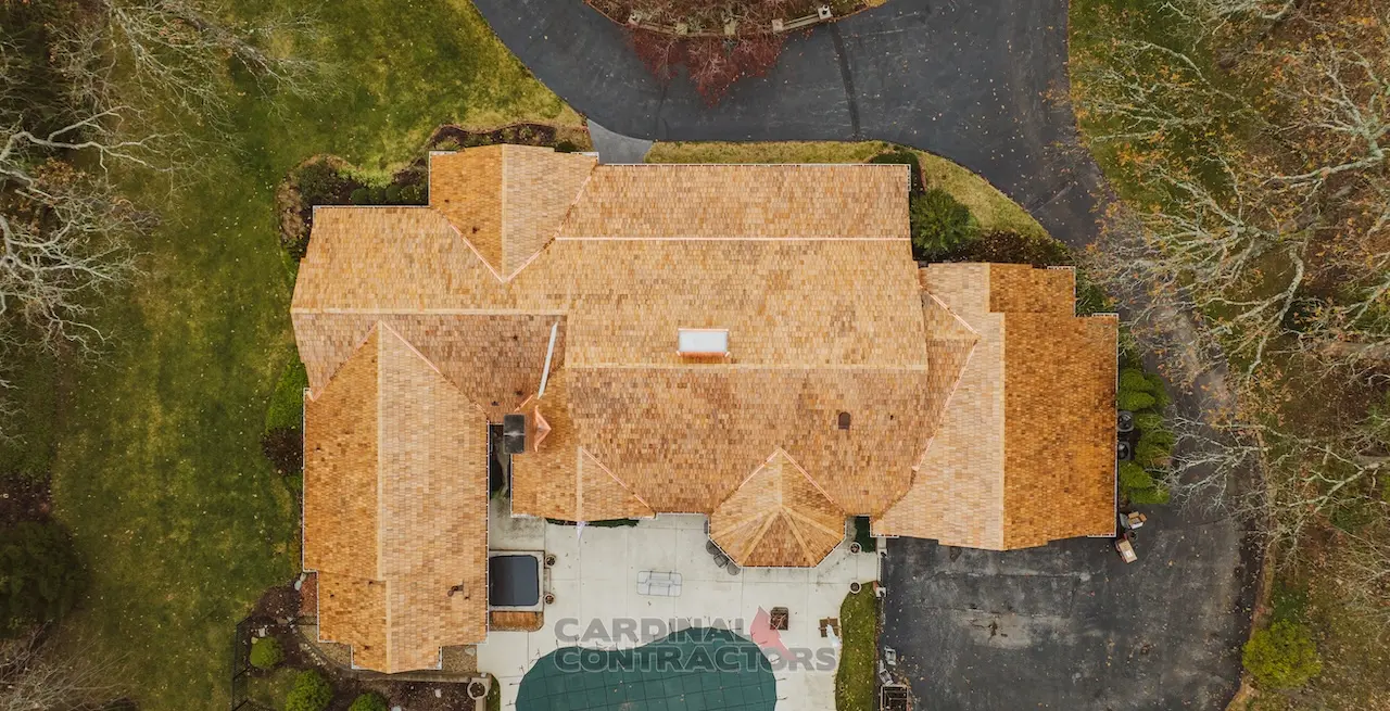 Overhead drone view of luxury estate with warm cedar shake style roof replacement and copper accents completed by Cardinal Contractors serving Kansas City and St. Louis Missouri