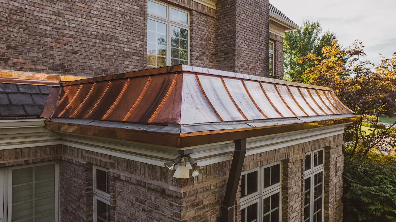 Close detail view of standing seam copper roof installation on historic brick manor completed by Cardinal Contractors serving Kansas City and St. Louis Missouri