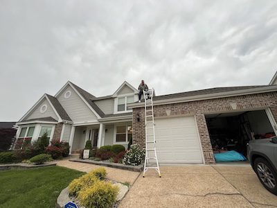 Cardinal Contractors roofer installing flat roof membrane on commercial property in Kansas City KS