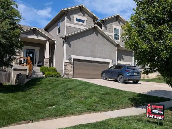 Cardinal Contractors yard sign at residential home for insurance claim roof replacement in Leawood KS