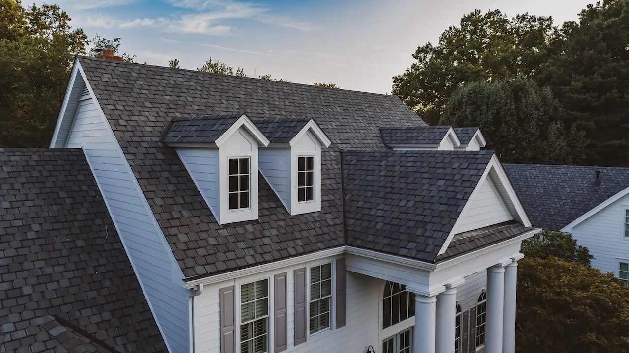 Close aerial view of dark architectural shingle roof replacement with dormer detail completed by Cardinal Contractors serving Kansas City and St. Louis Missouri