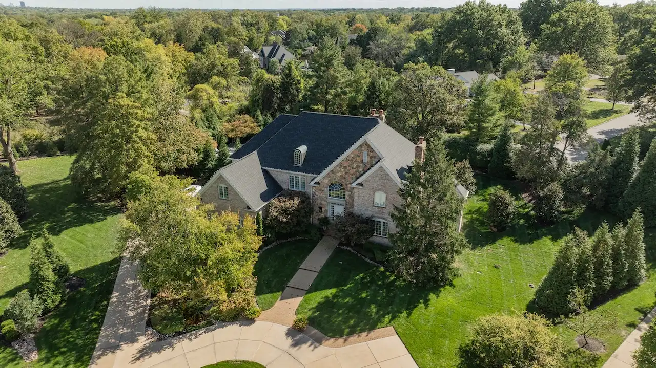 Aerial drone view of luxury residential roof replacement completed by Cardinal Contractors in Overland Park KS