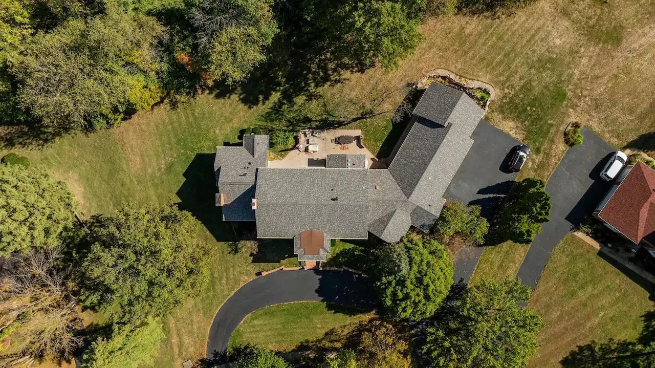 Overhead drone view of large multi-pitch estate roof replacement completed by Cardinal Contractors in Prairie Village KS