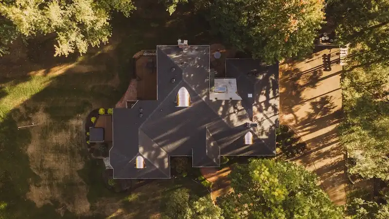 Aerial drone view of residential home exterior and roof by Cardinal Contractors serving Kansas City and St. Louis Missouri
