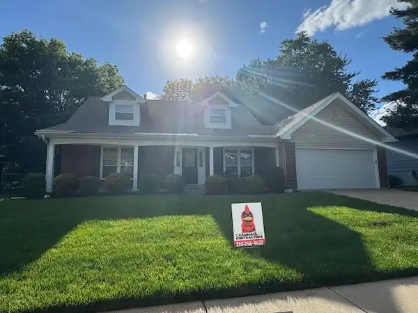 Cardinal Contractors yard sign at residential home after storm damage roof repair in Prairie Village KS