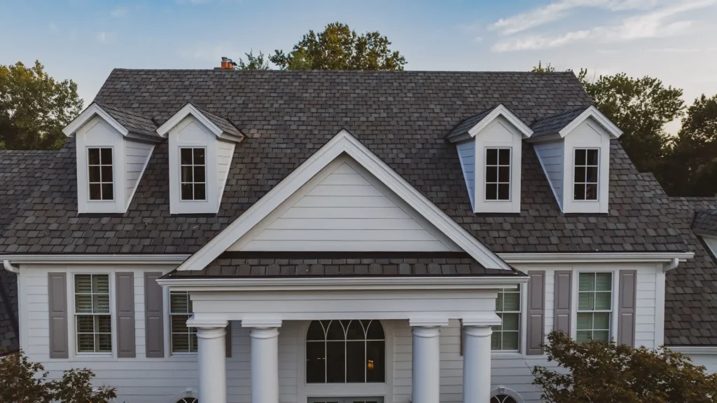 Close aerial view of luxury colonial estate with white siding installation and dormer windows completed by Cardinal Contractors in St. Louis MO