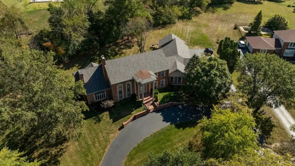 Aerial view of brick Georgian colonial estate with storm damage roof assessment by Cardinal Contractors in St. Louis MO